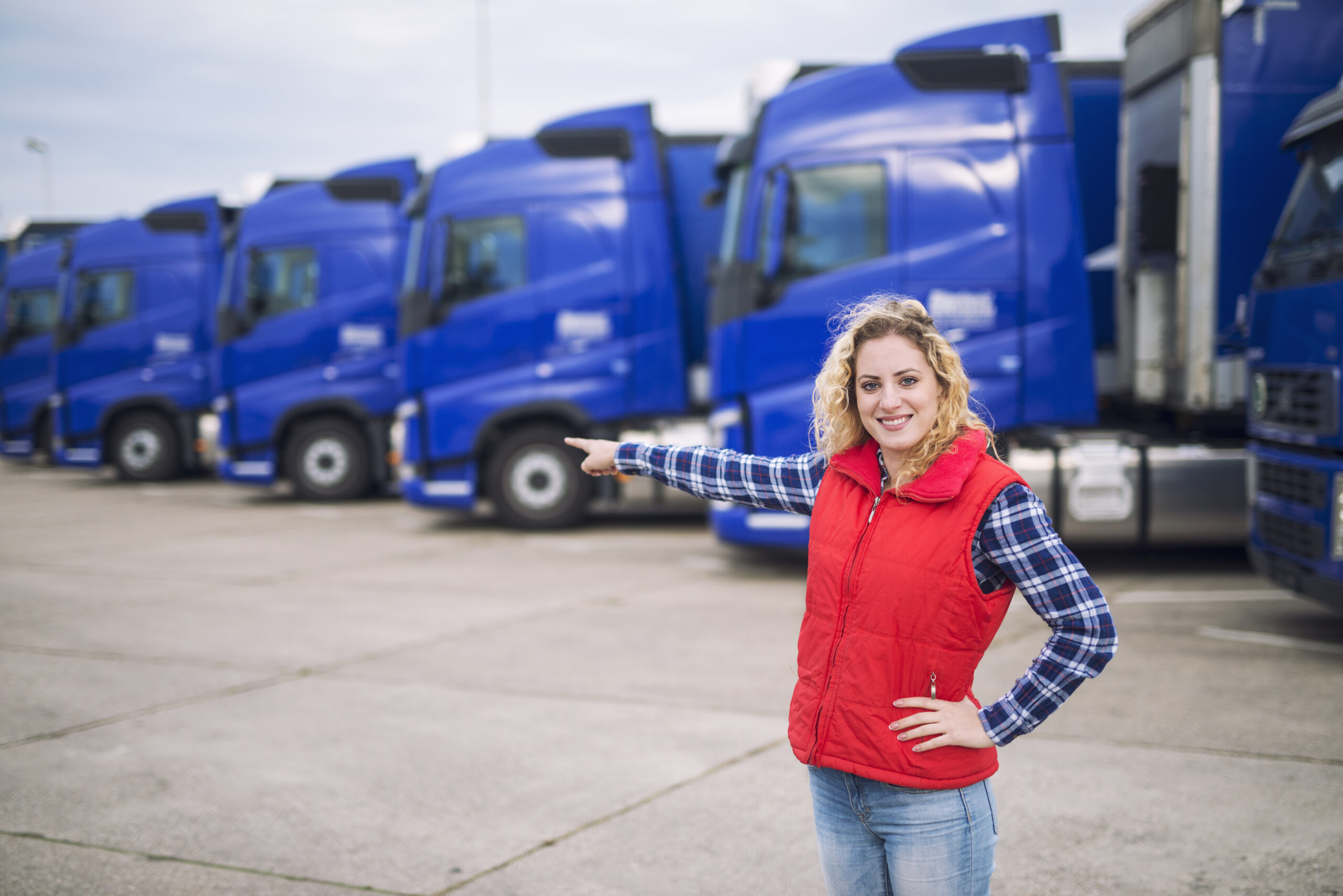 Parked commercial trucks representing the 2024 Mack Anthem listing